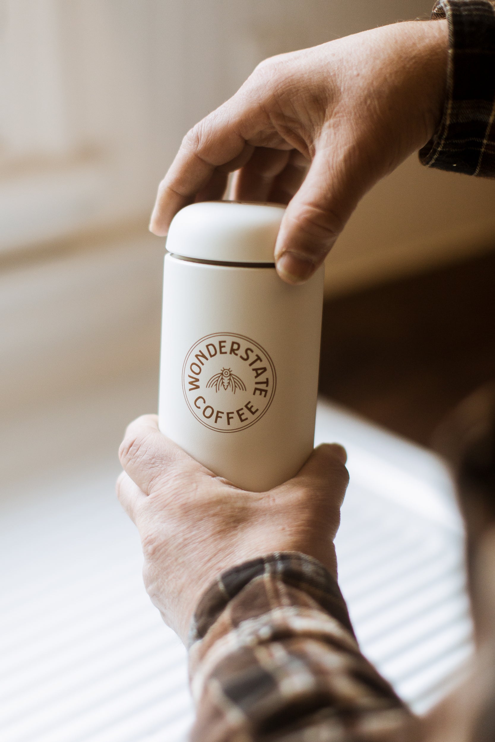 Person opening Wonderstate Carter Move Mug in White