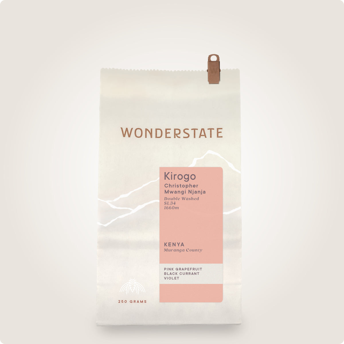 A 350g bag of Wonderstate Kirogo coffee on a clean, light off-white background. The packaging is off-white with a dusty pink label block, white minimalist mountain line art, and brown text and a brown hanging loop.